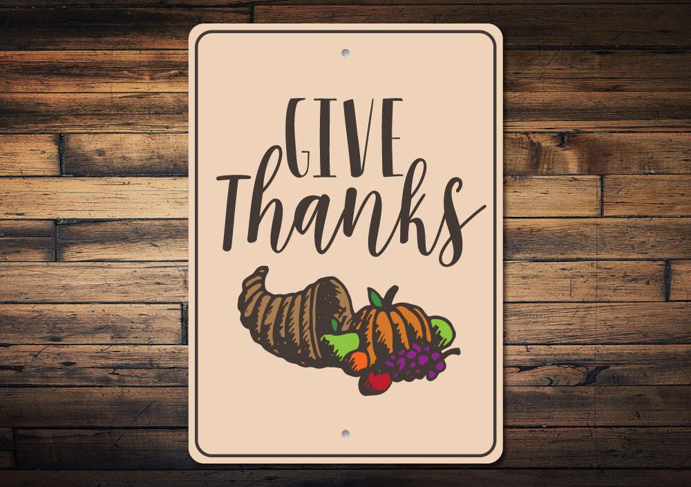 A beautifully crafted Give Thanks sign made of high-quality aluminum, featuring elegant lettering and a rustic design, perfect for home decor.