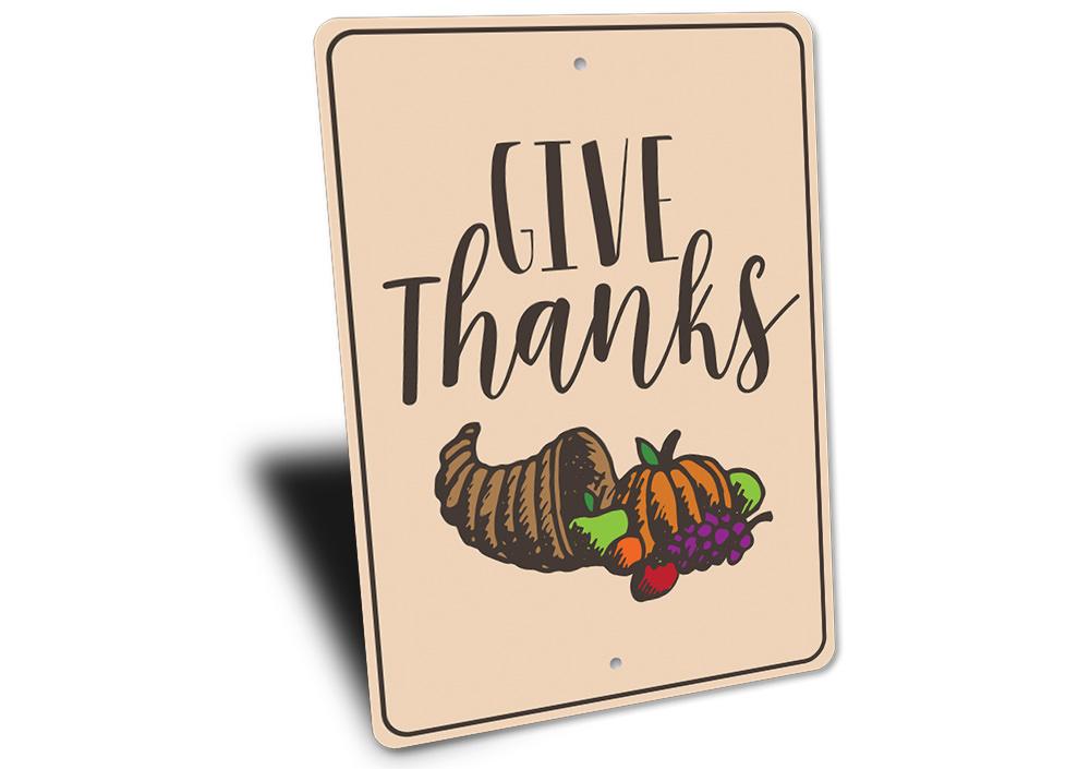 A beautifully crafted Give Thanks sign made of high-quality aluminum, featuring elegant lettering and a rustic design, perfect for home decor.