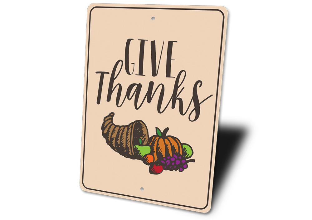 A beautifully crafted Give Thanks sign made of high-quality aluminum, featuring elegant lettering and a rustic design, perfect for home decor.