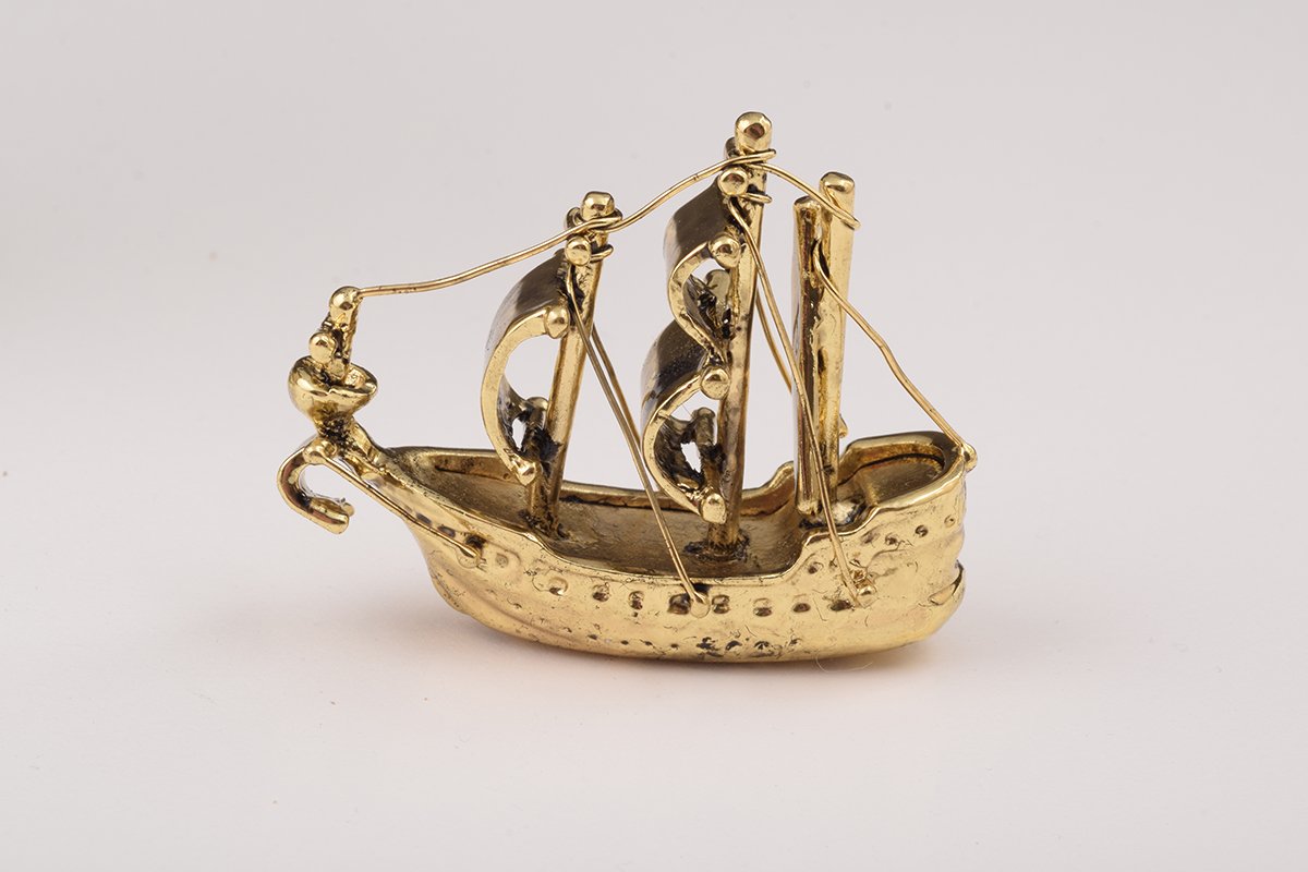 A beautifully crafted Globe Faberge Egg trinket box featuring a sailing ship design, adorned with Austrian crystals and plated in 24K gold or 925 silver.