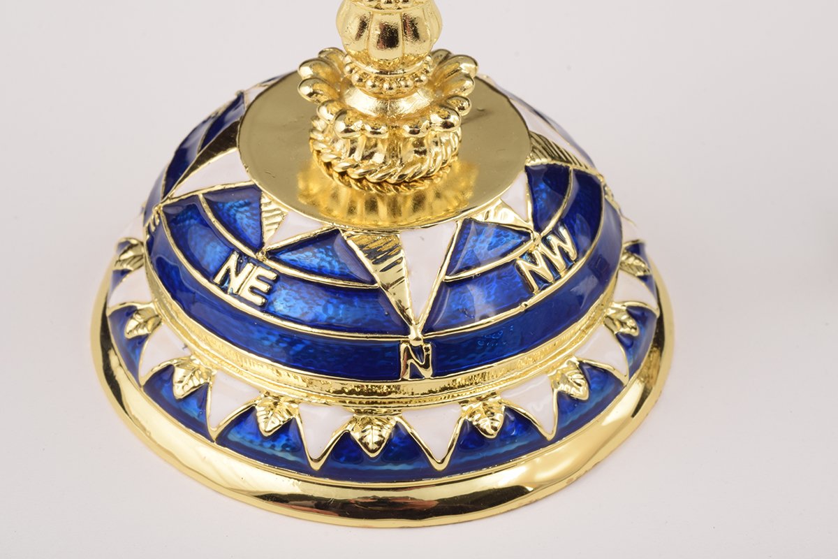 A beautifully crafted Globe Faberge Egg trinket box featuring a sailing ship design, adorned with Austrian crystals and plated in 24K gold or 925 silver.