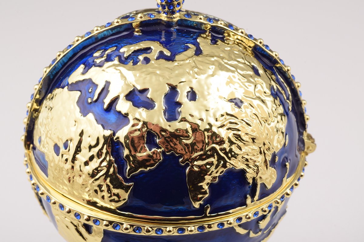 A beautifully crafted Globe Faberge Egg trinket box featuring a sailing ship design, adorned with Austrian crystals and plated in 24K gold or 925 silver.