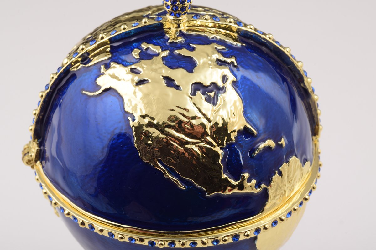 A beautifully crafted Globe Faberge Egg trinket box featuring a sailing ship design, adorned with Austrian crystals and plated in 24K gold or 925 silver.