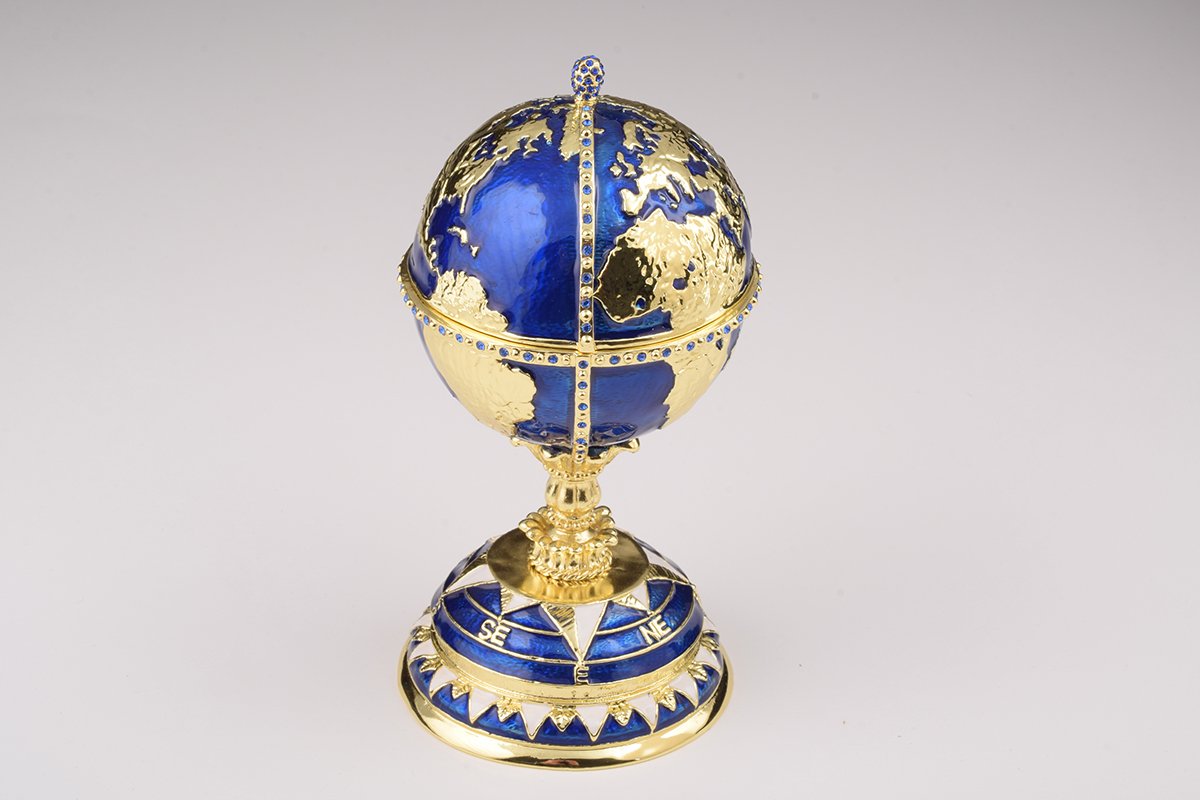 A beautifully crafted Globe Faberge Egg trinket box featuring a sailing ship design, adorned with Austrian crystals and plated in 24K gold or 925 silver.