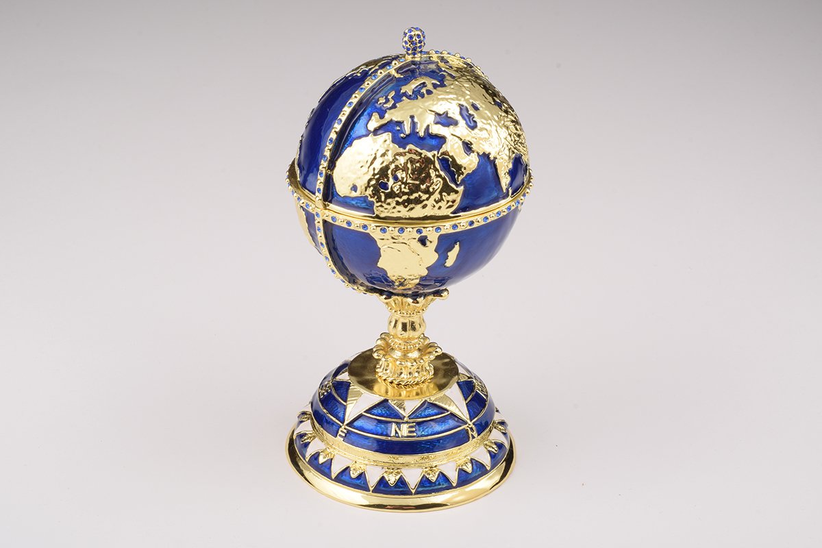 A beautifully crafted Globe Faberge Egg trinket box featuring a sailing ship design, adorned with Austrian crystals and plated in 24K gold or 925 silver.