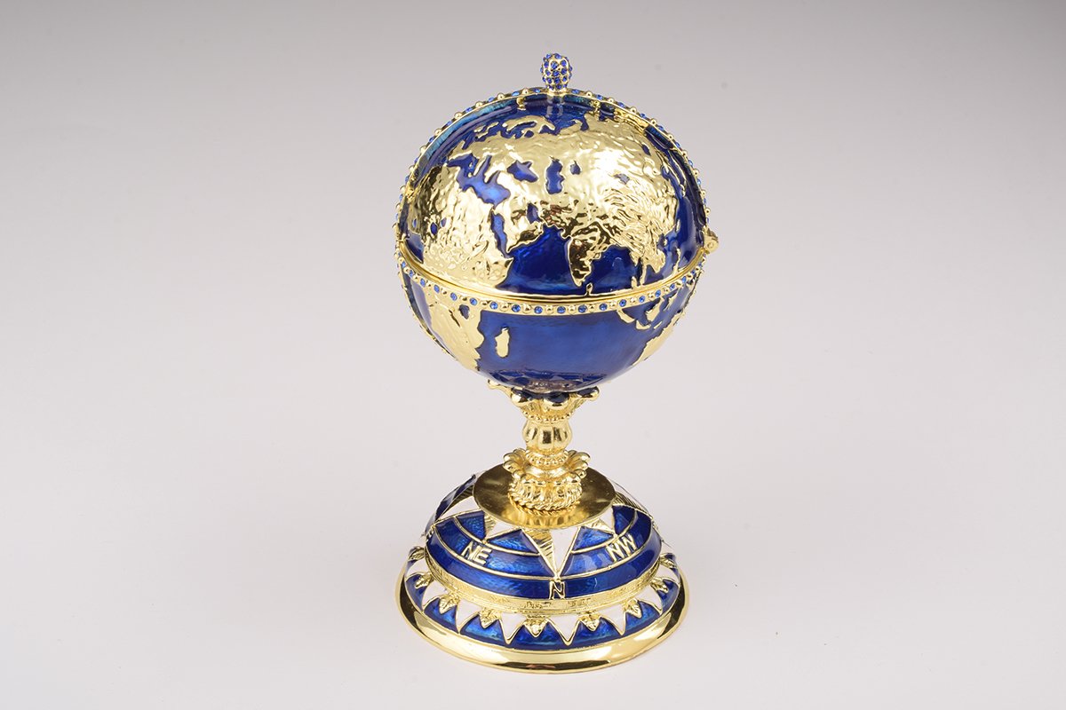 A beautifully crafted Globe Faberge Egg trinket box featuring a sailing ship design, adorned with Austrian crystals and plated in 24K gold or 925 silver.