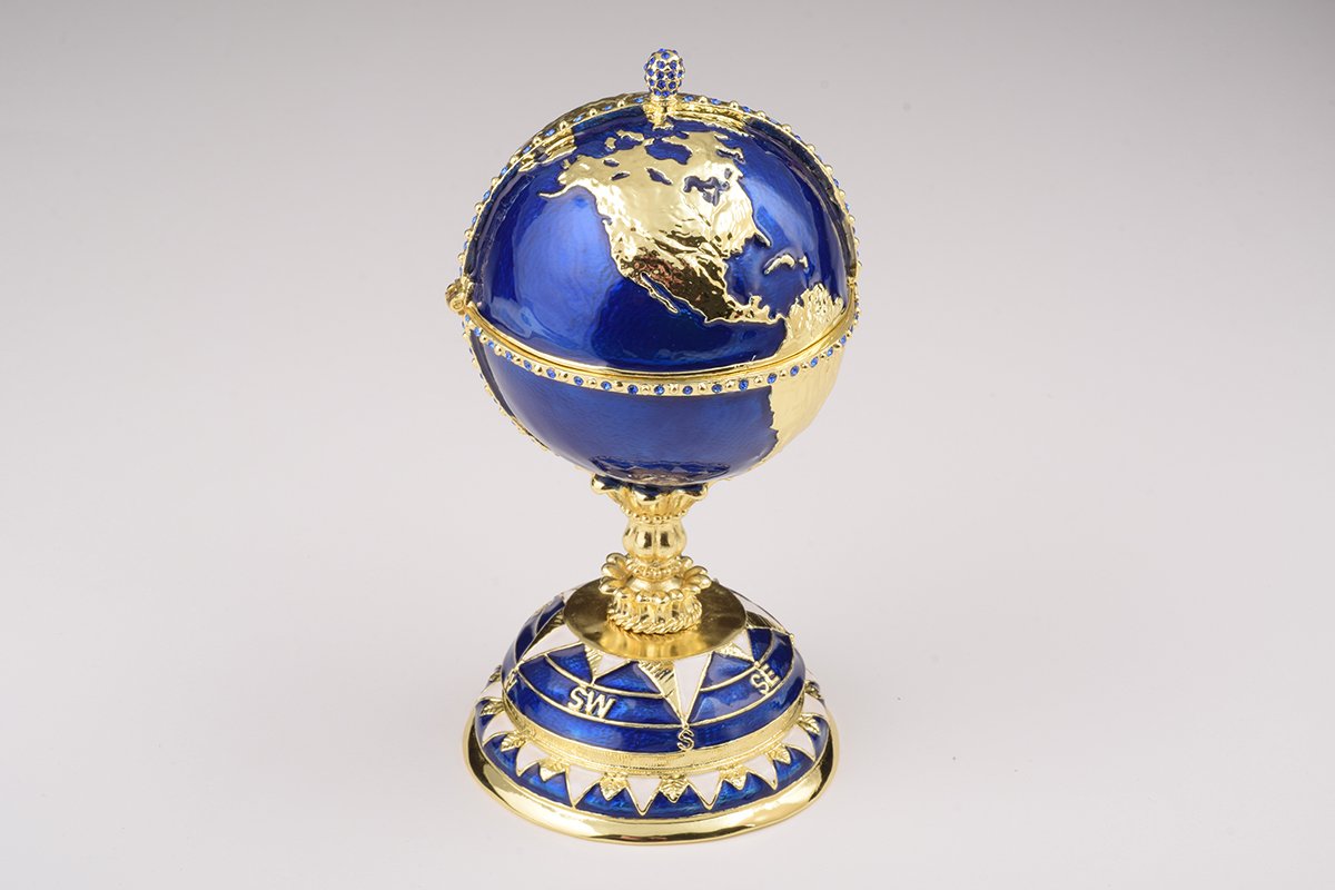 A beautifully crafted Globe Faberge Egg trinket box featuring a sailing ship design, adorned with Austrian crystals and plated in 24K gold or 925 silver.