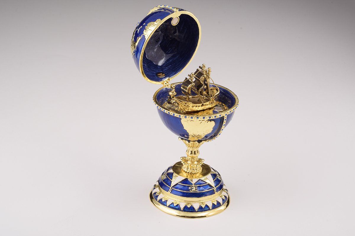 A beautifully crafted Globe Faberge Egg trinket box featuring a sailing ship design, adorned with Austrian crystals and plated in 24K gold or 925 silver.