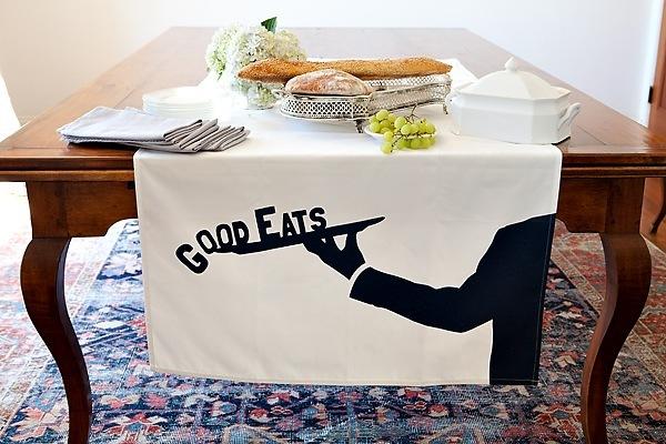 Good Eats table banner in white fabric, showcasing elegant design and generous size for parties.