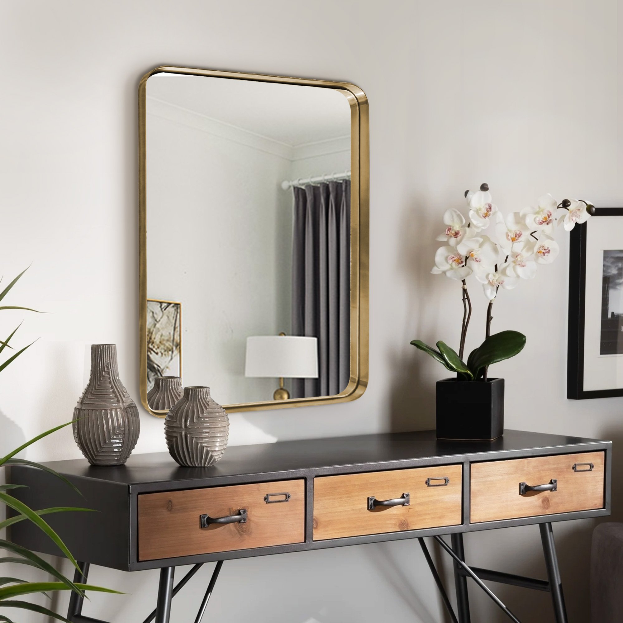 A luxurious gold bathroom hanging mirror measuring 22x30 inches, featuring a hand-brushed brass frame with round corners and an infinity design.