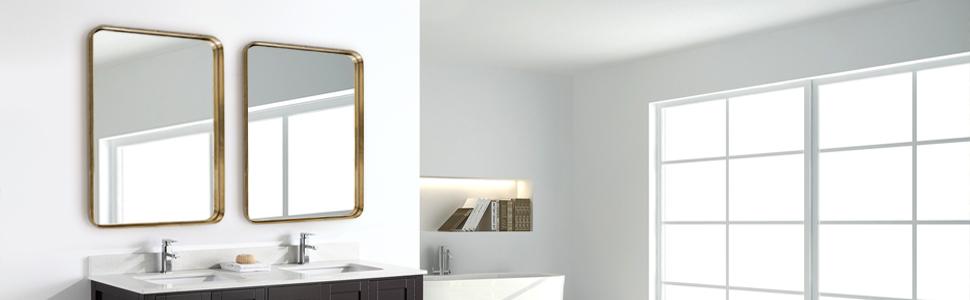 A luxurious gold bathroom hanging mirror measuring 22x30 inches, featuring a hand-brushed brass frame with round corners and an infinity design.