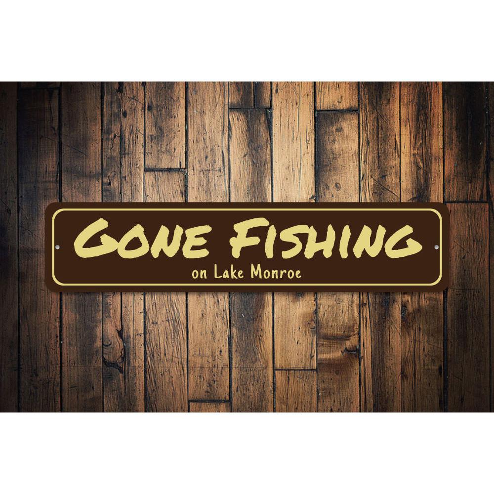 A decorative Gone Fishing sign made of durable aluminum, featuring a fishing theme, perfect for lakehouses and outdoor decor.