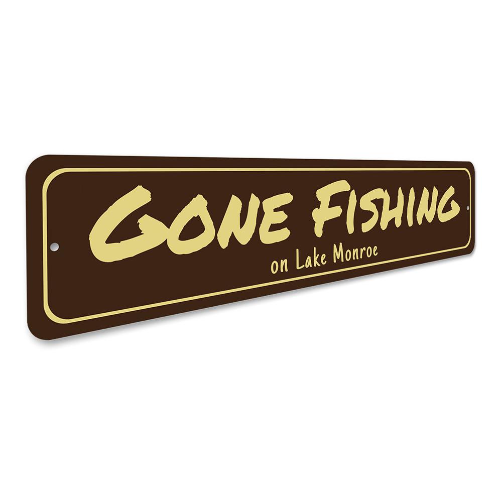 A decorative Gone Fishing sign made of durable aluminum, featuring a fishing theme, perfect for lakehouses and outdoor decor.