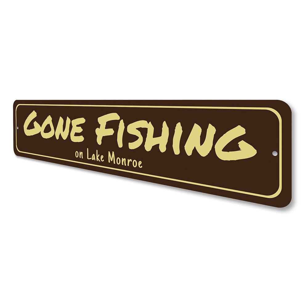 A decorative Gone Fishing sign made of durable aluminum, featuring a fishing theme, perfect for lakehouses and outdoor decor.