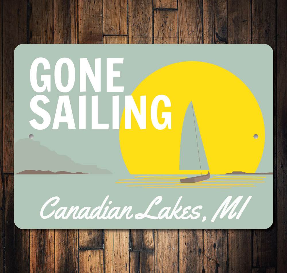 Gone Sailing Sign made of durable aluminum, featuring nautical-themed design, perfect for lakehouse decor.