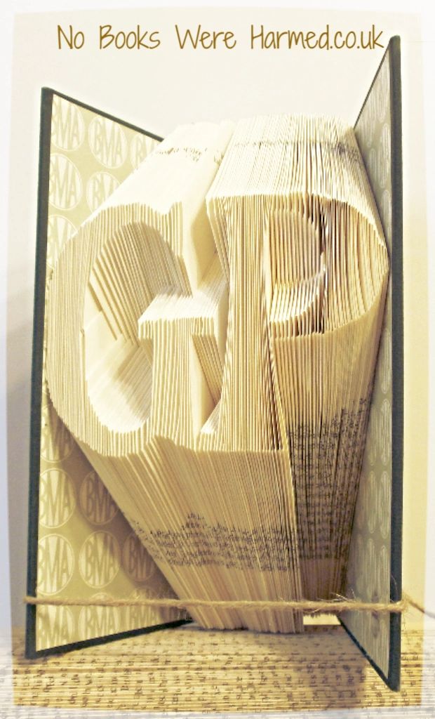 Hand-folded book art featuring the letters 'GP', crafted from vintage books, perfect for General Practitioners' decor.