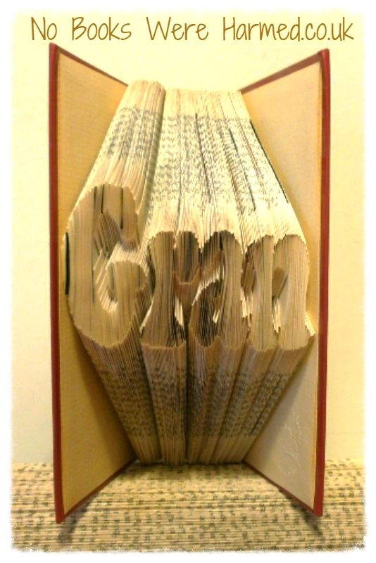 Hand-folded book art made from vintage books, showcasing intricate designs and unique colors.