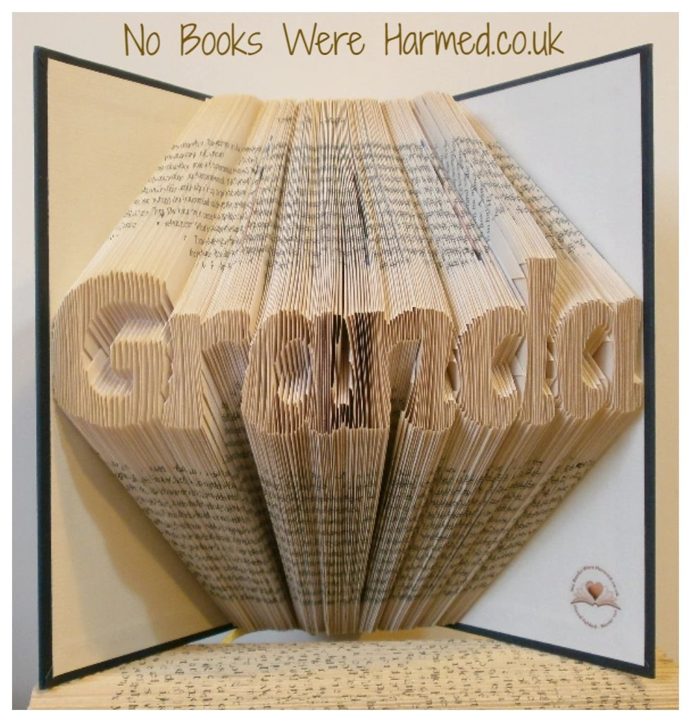 Handcrafted Granda art piece made from vintage book pages, showcasing unique folds and textures.