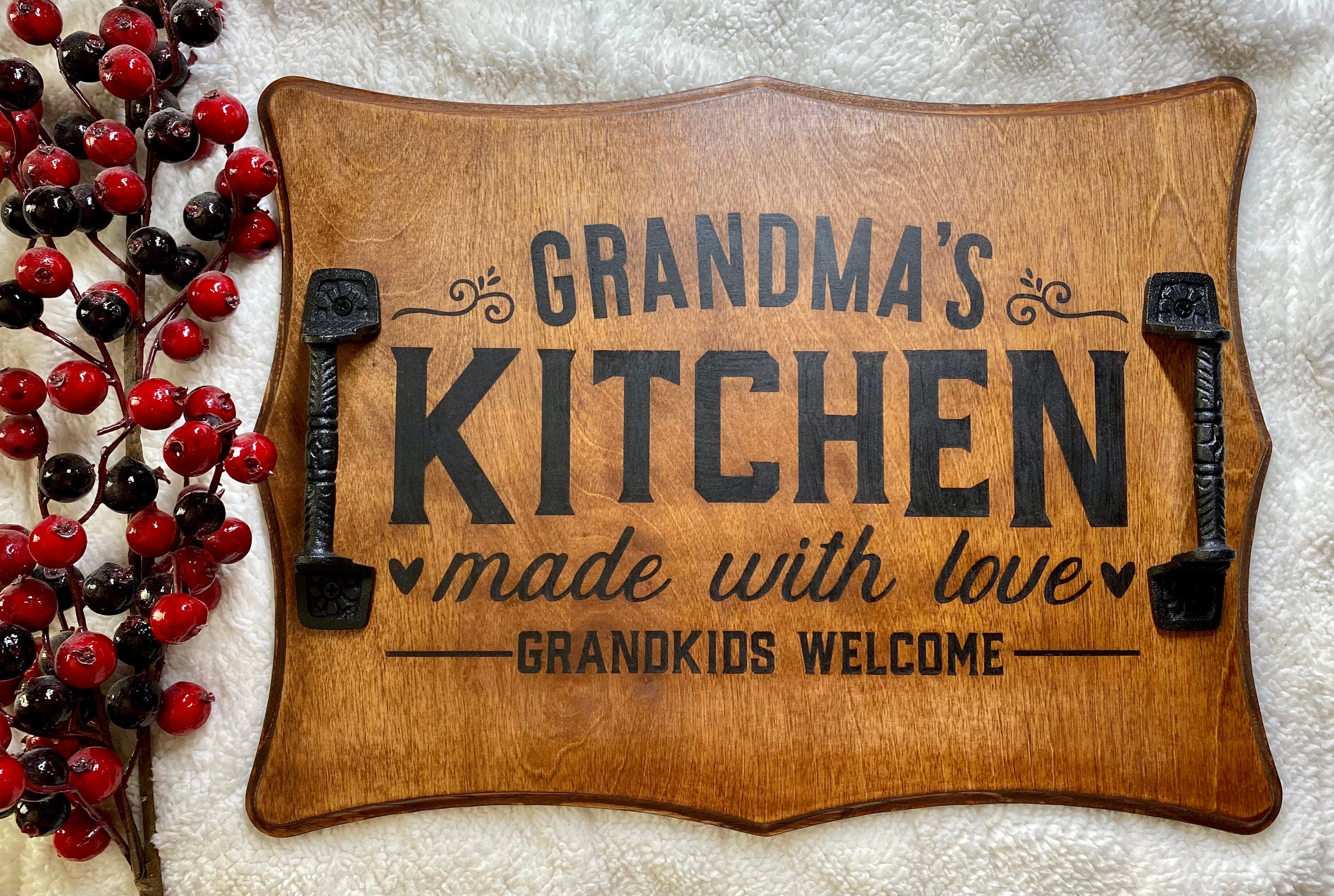 Handmade wooden serving tray with cast iron handles, stained in rich chestnut color, featuring a unique burned design.