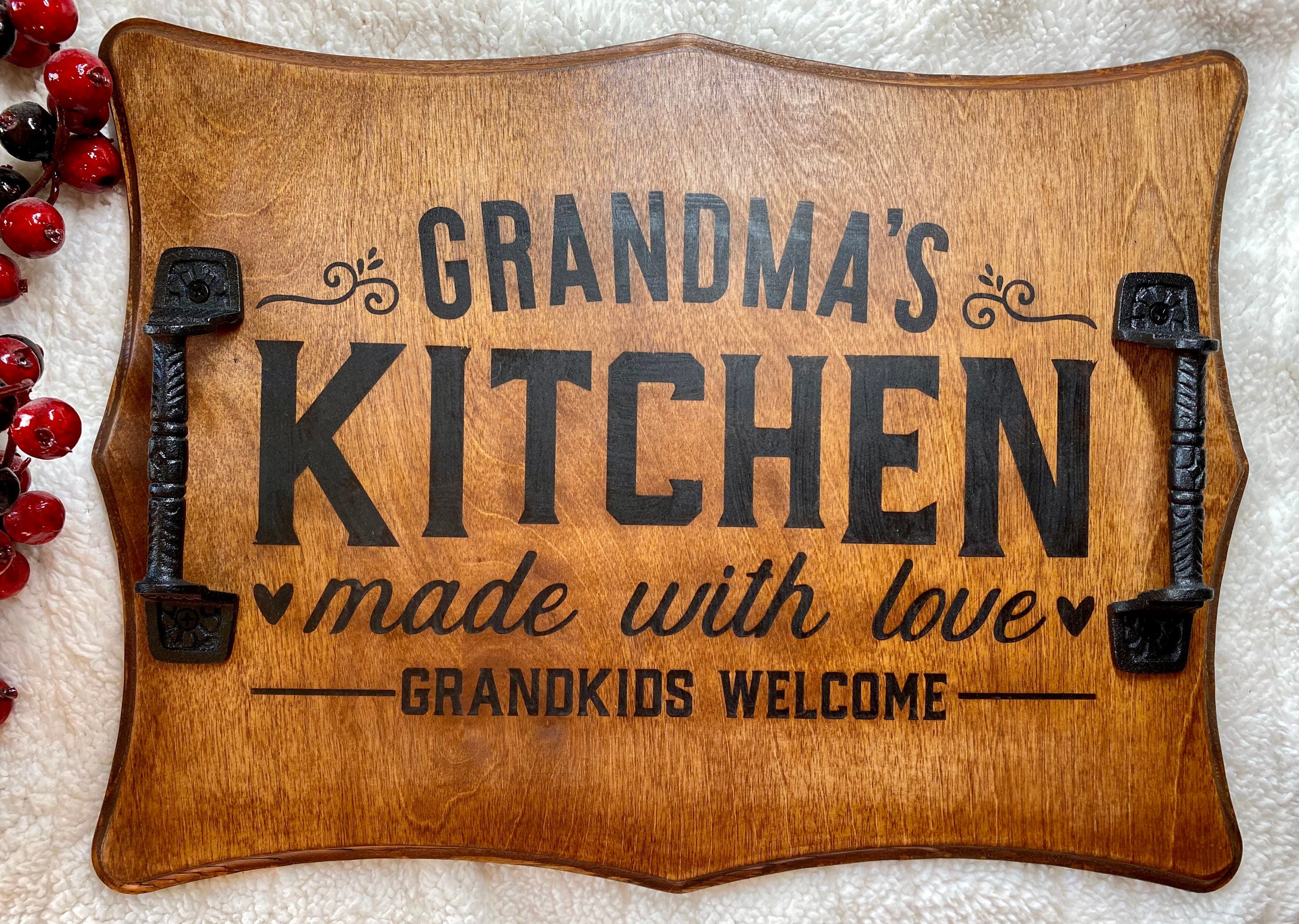 Handmade wooden serving tray with cast iron handles, stained in rich chestnut color, featuring a unique burned design.