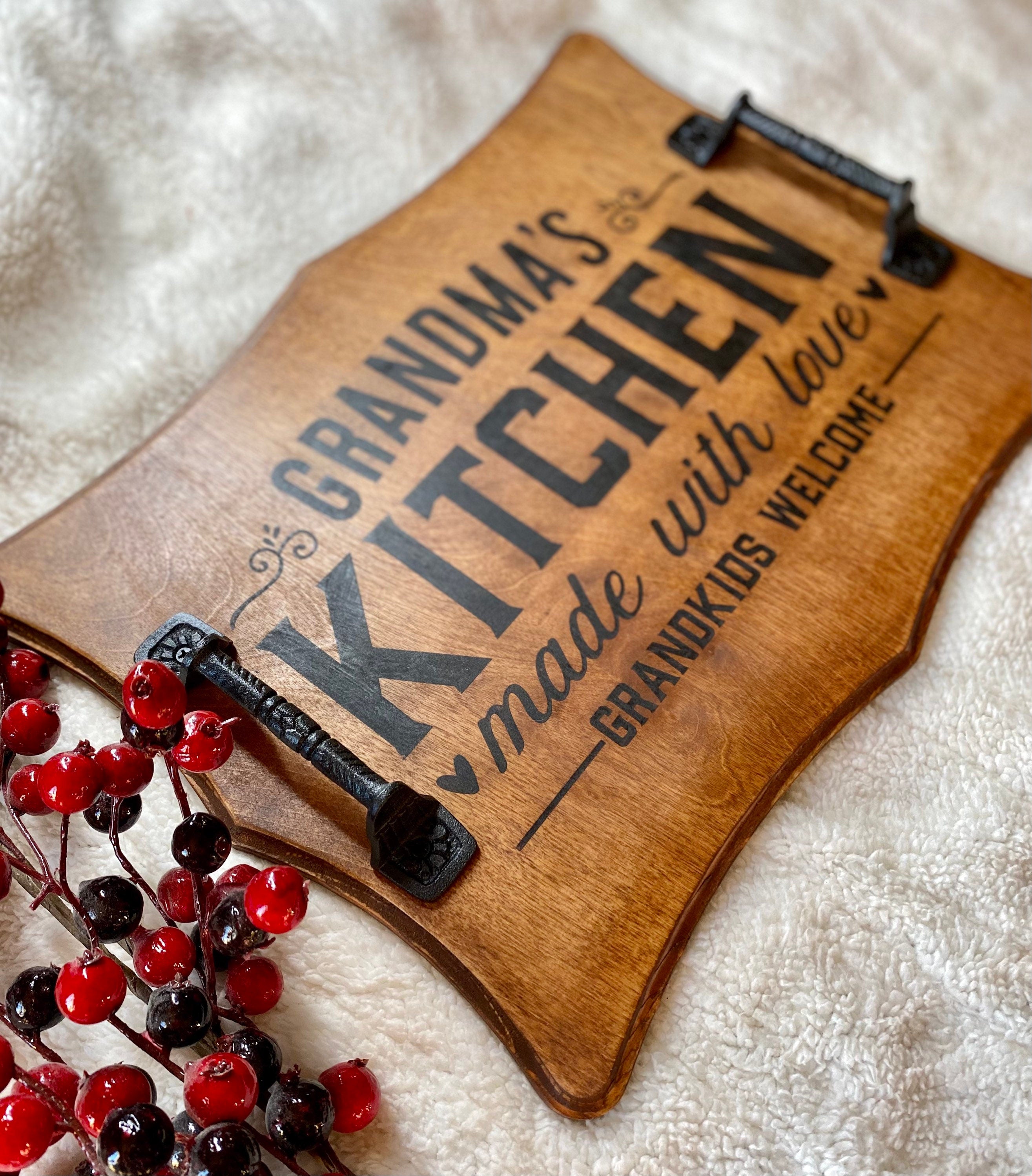 Handmade wooden serving tray with cast iron handles, stained in rich chestnut color, featuring a unique burned design.