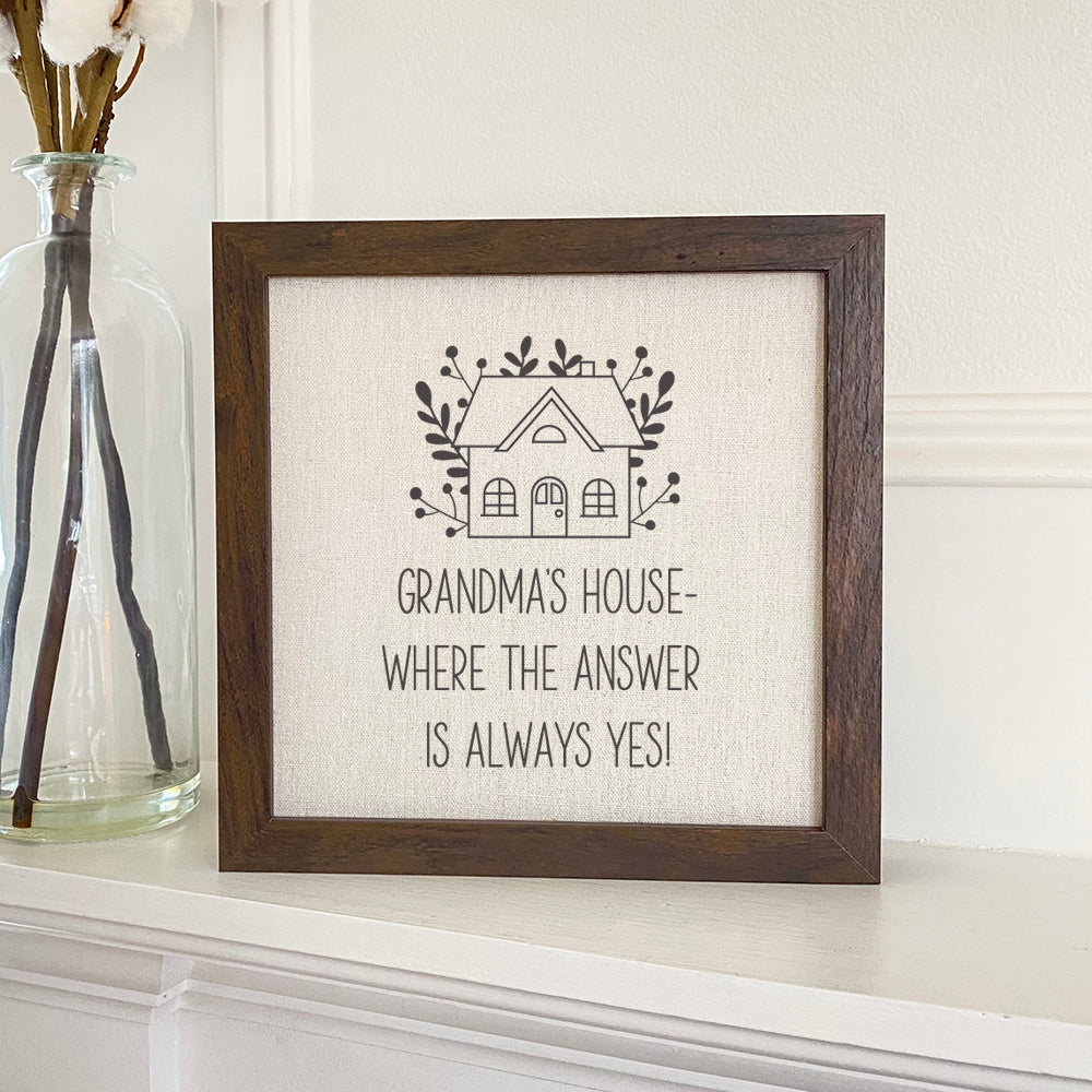 Framed sign reading 'Grandma's / Nana's Answer is Yes' with a stylish wood frame and linen-look background.