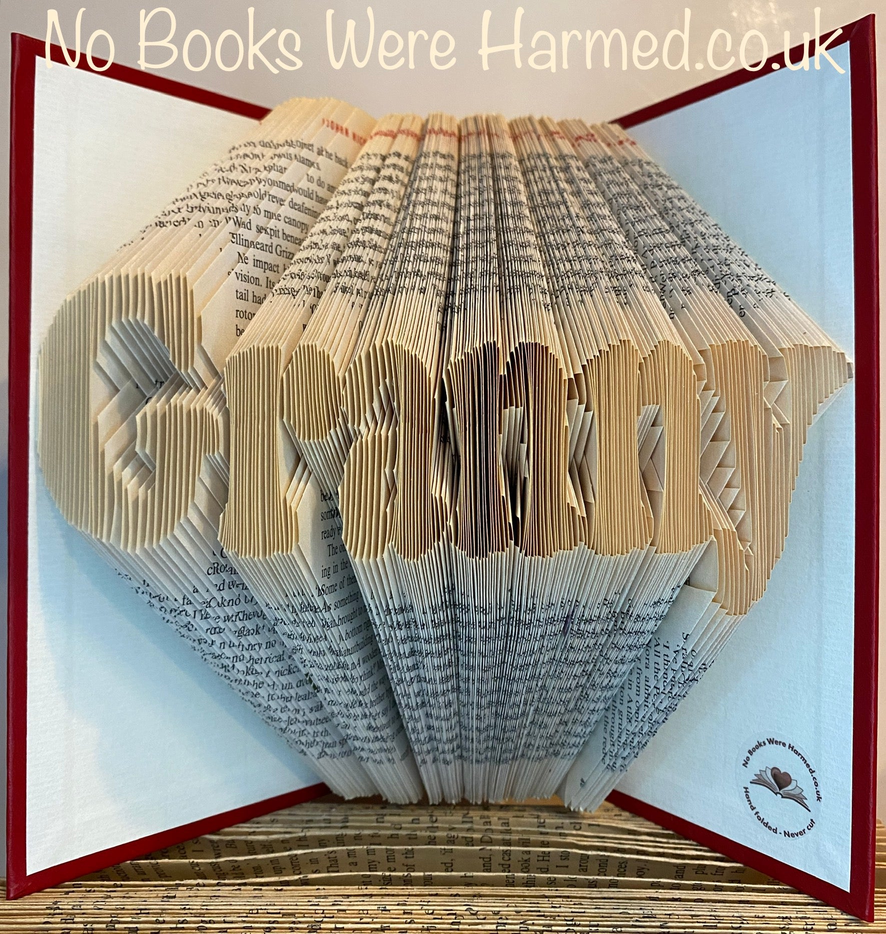 Handcrafted Granny book art made from vintage books, showcasing unique folded pages in various colors and textures.