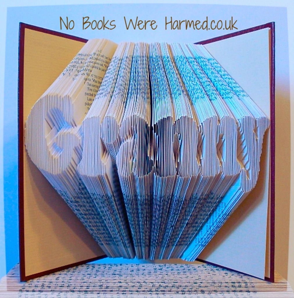 Handcrafted Granny book art made from vintage books, showcasing unique folded pages in various colors and textures.