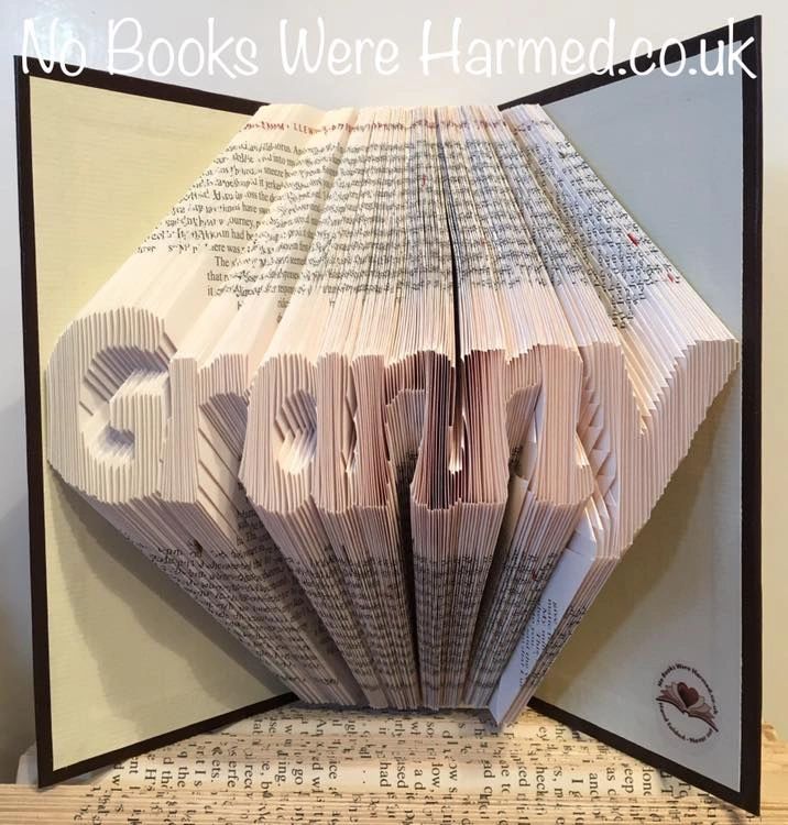 Handcrafted art piece from vintage books, showcasing unique folded pages and colors.