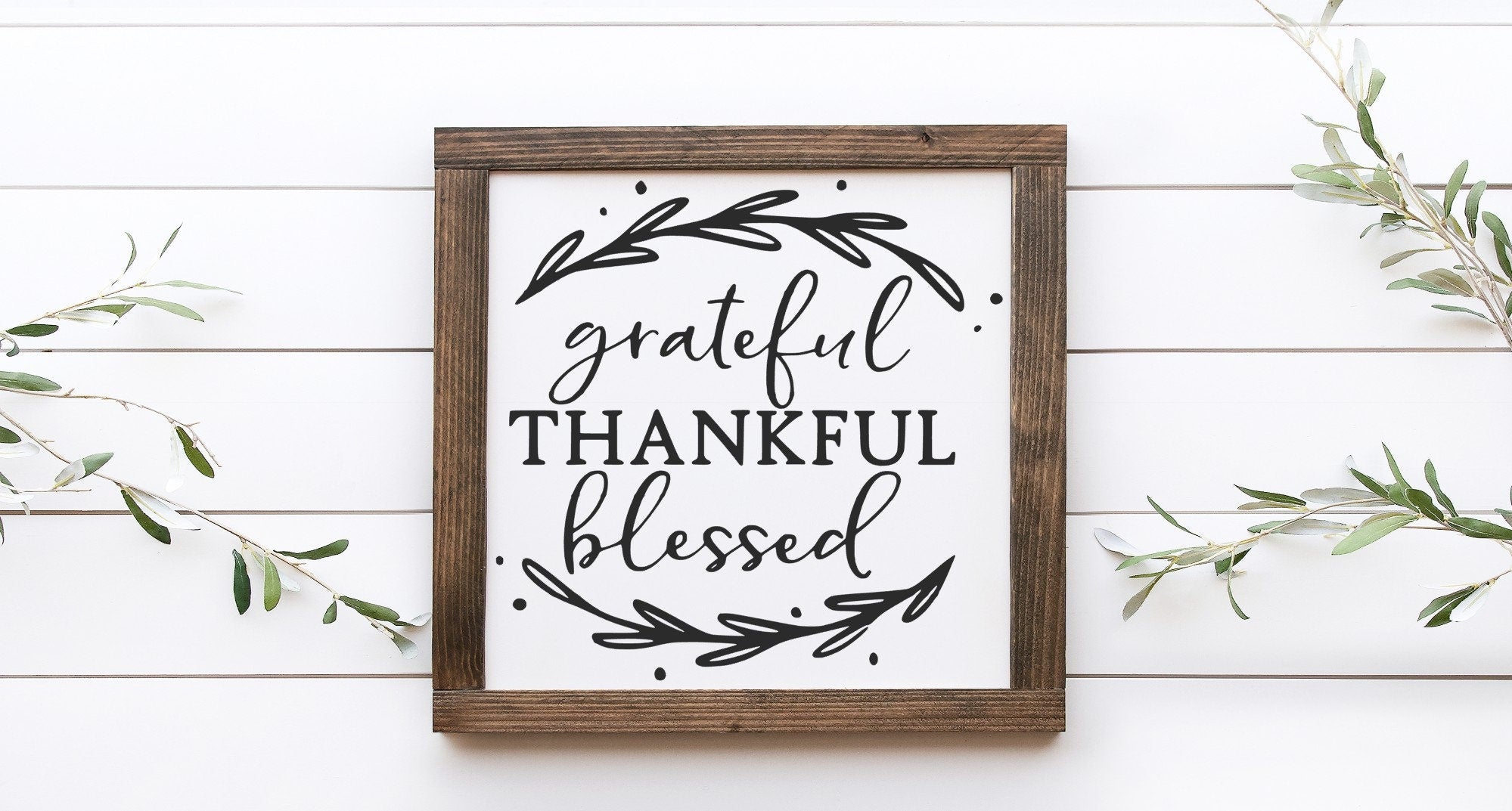 Grateful Thankful Blessed wood sign with a matte white background and black lettering, showcasing unique wood grain and knots.