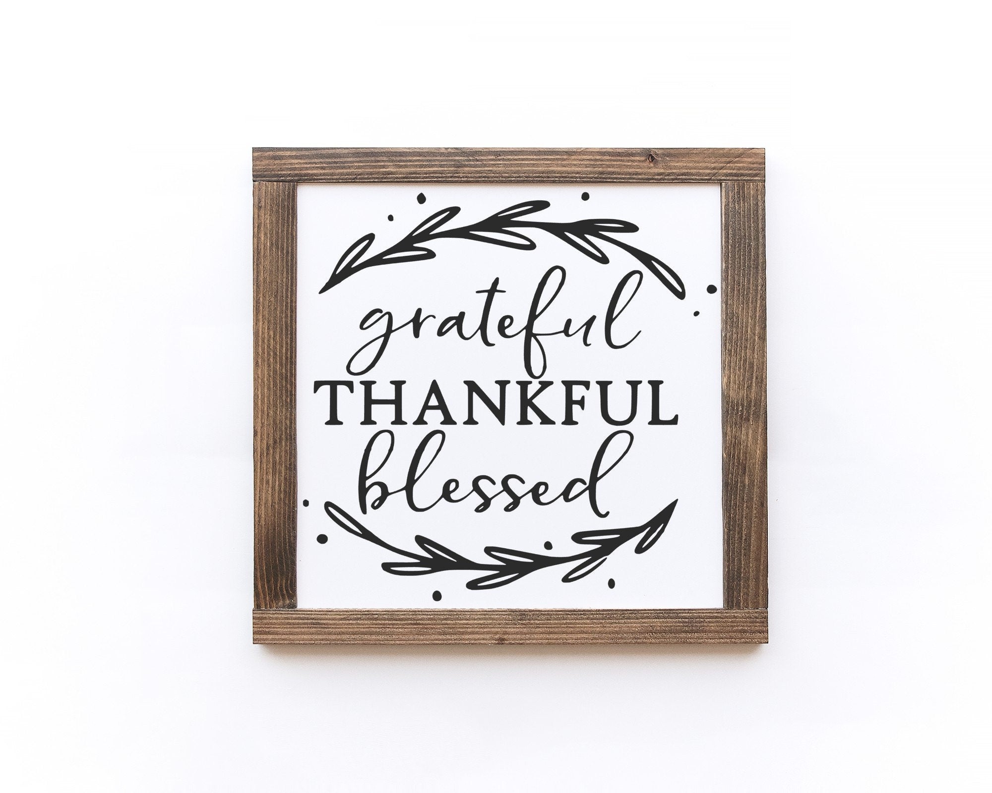 Grateful Thankful Blessed wood sign with a matte white background and black lettering, showcasing unique wood grain and knots.