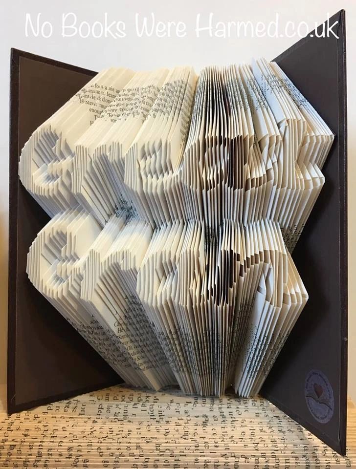 Handcrafted art piece made from vintage book pages, showcasing intricate folds and unique design.