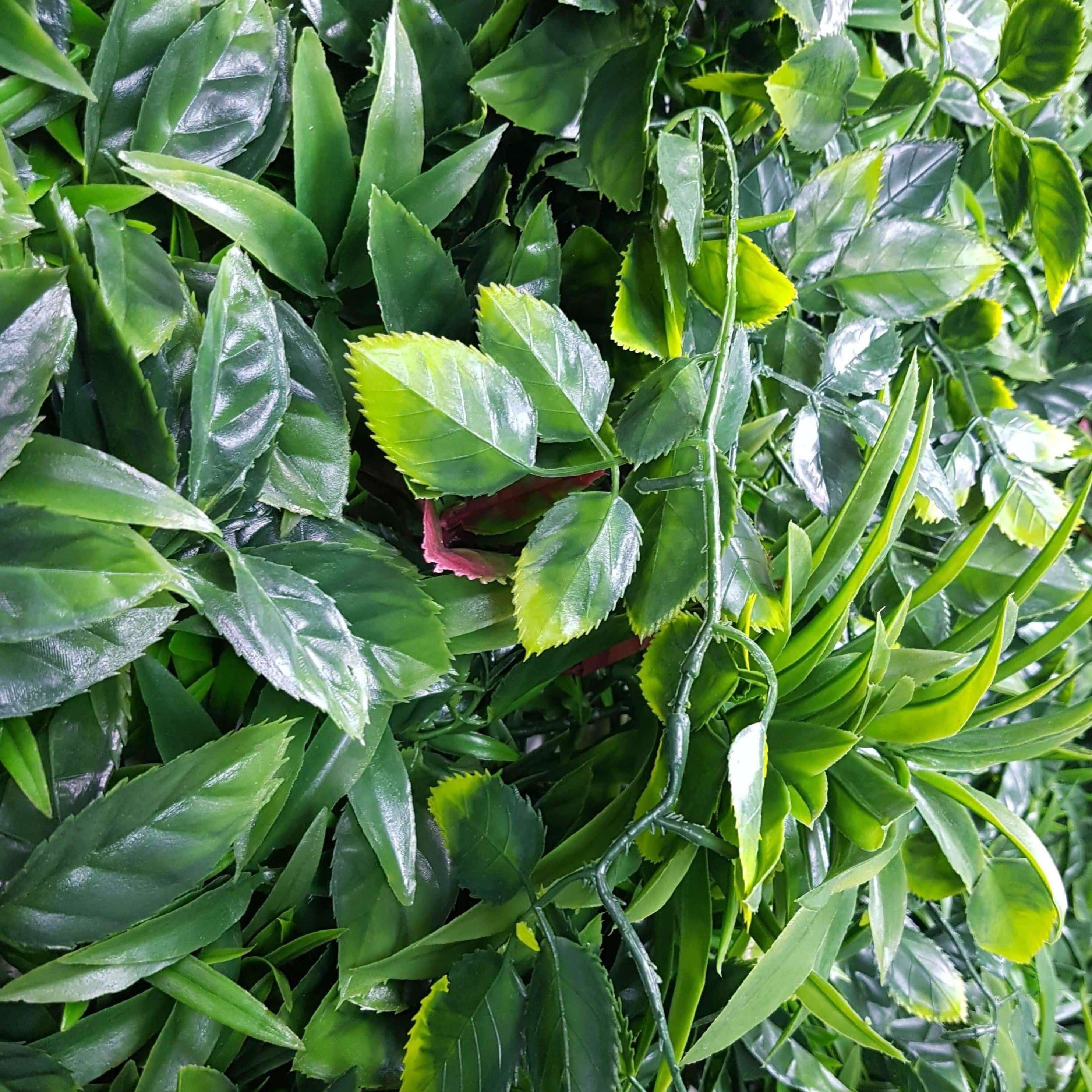 A vibrant Green Meadows Artificial Vertical Garden panel showcasing a variety of lush green plants, perfect for indoor and outdoor decoration.