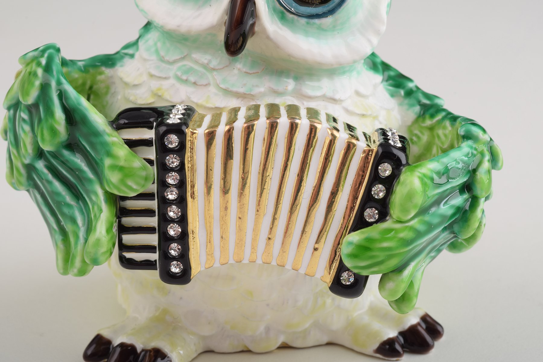 Handmade Green Owl Playing Accordion Trinket Box with Austrian crystals and 24K gold plating, featuring a secure magnetic fastener.