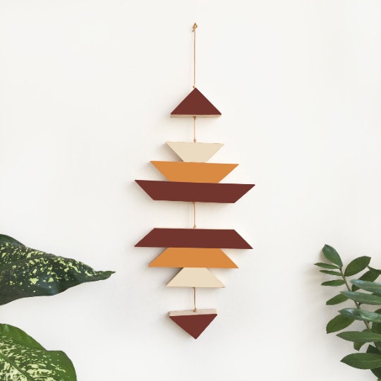 A green ombre small wooden wall hanging featuring geometric designs, connected with brown wax cotton cord, ideal for modern decor.