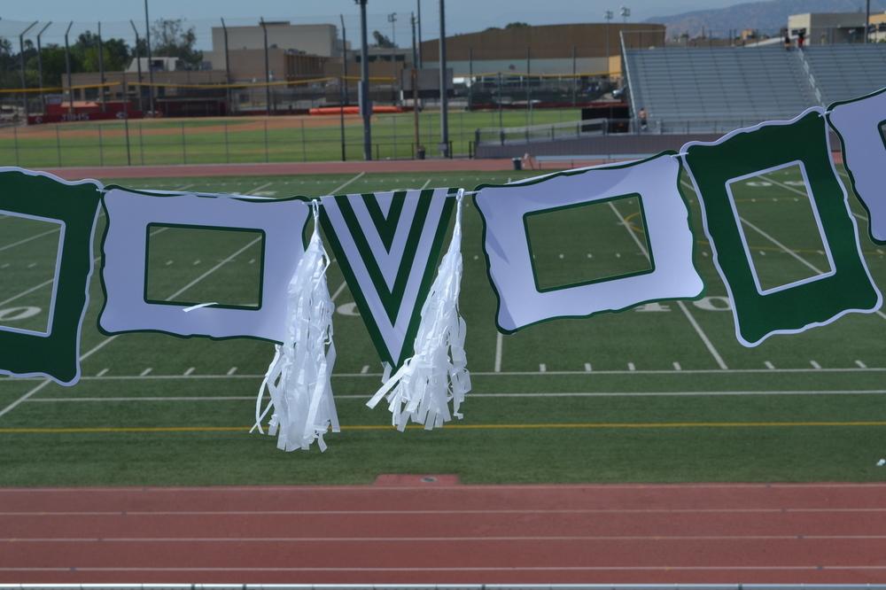 Green and white party decoration set featuring paper frames, pennant, ribbon, and tassels for festive celebrations.