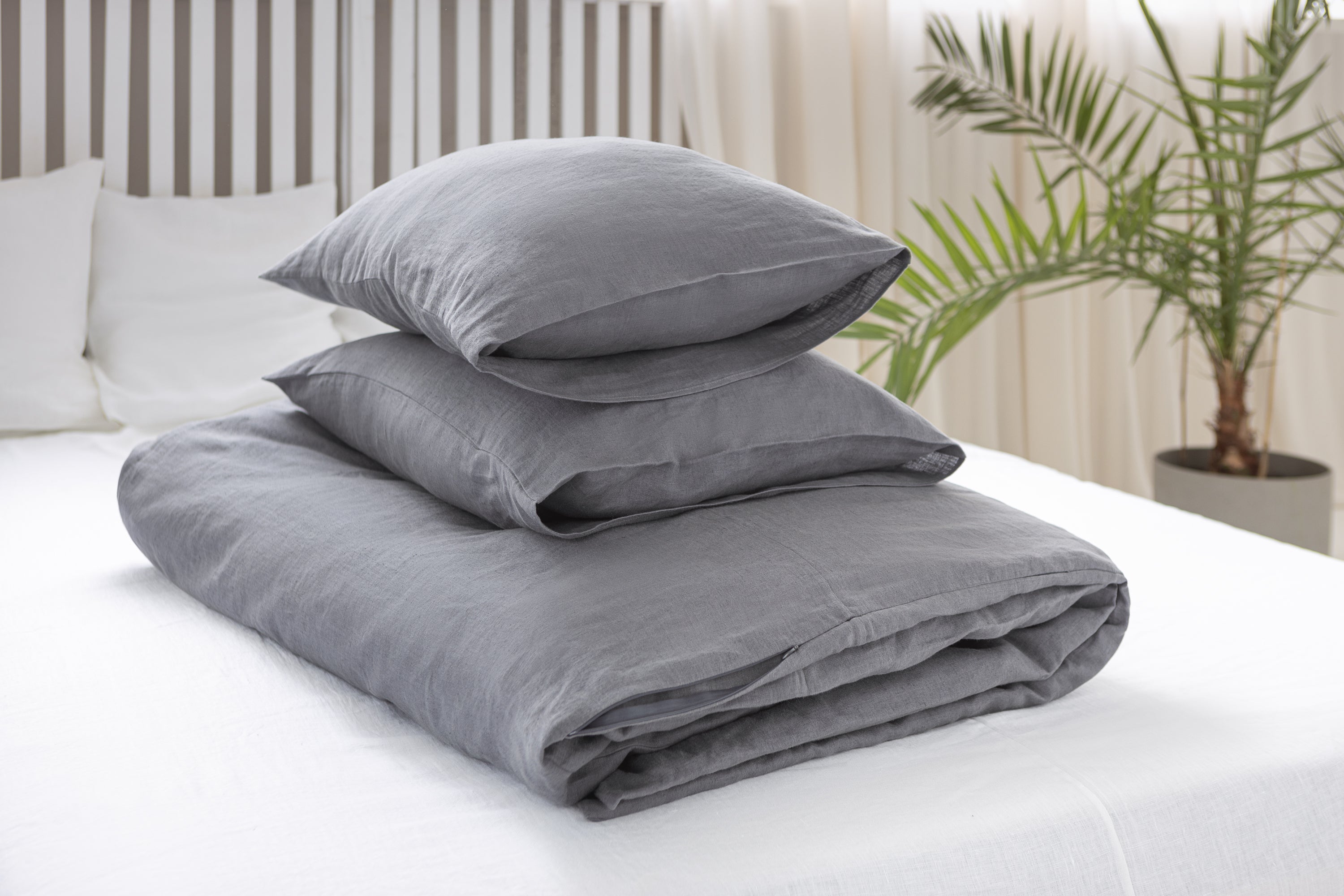 Elegant grey linen bedding set featuring a zipper duvet cover and envelope pillowcases, showcasing a minimalist Scandinavian design.