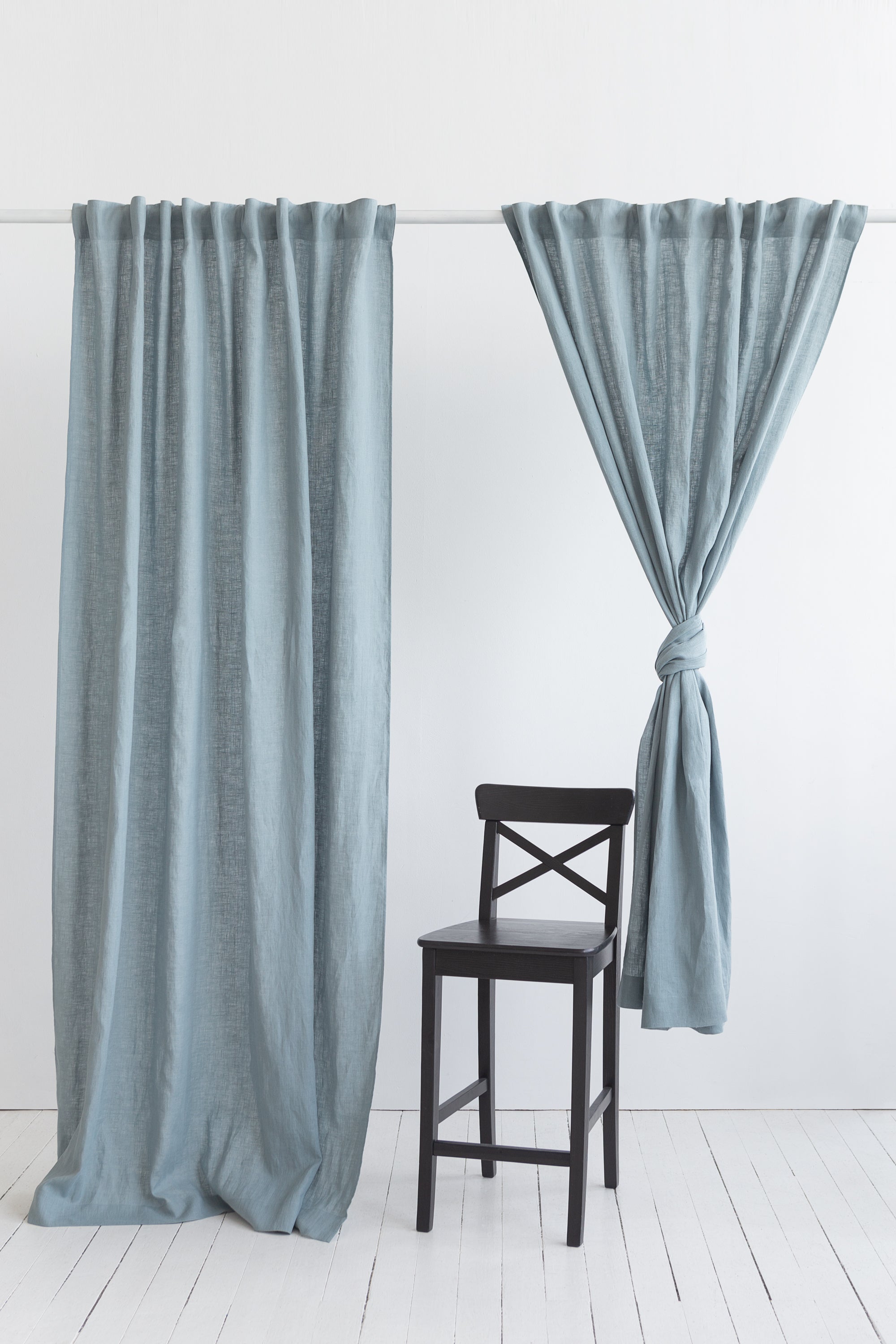 Soft greyish mint linen curtain with multifunctional tape, elegantly draped to showcase its semi-sheer texture and versatile hanging options.