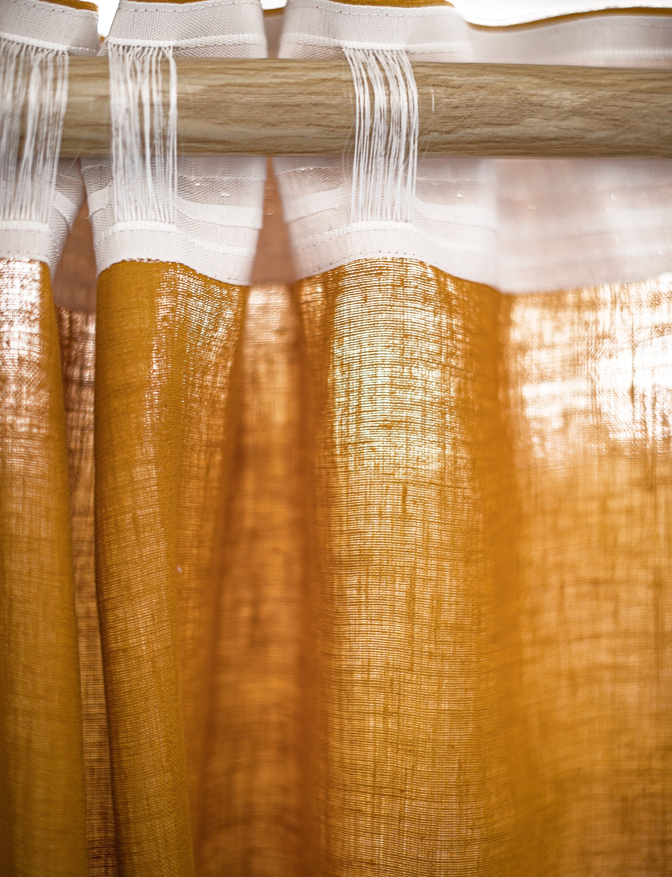 Soft greyish mint linen curtain with multifunctional tape, elegantly draped to showcase its semi-sheer texture and versatile hanging options.