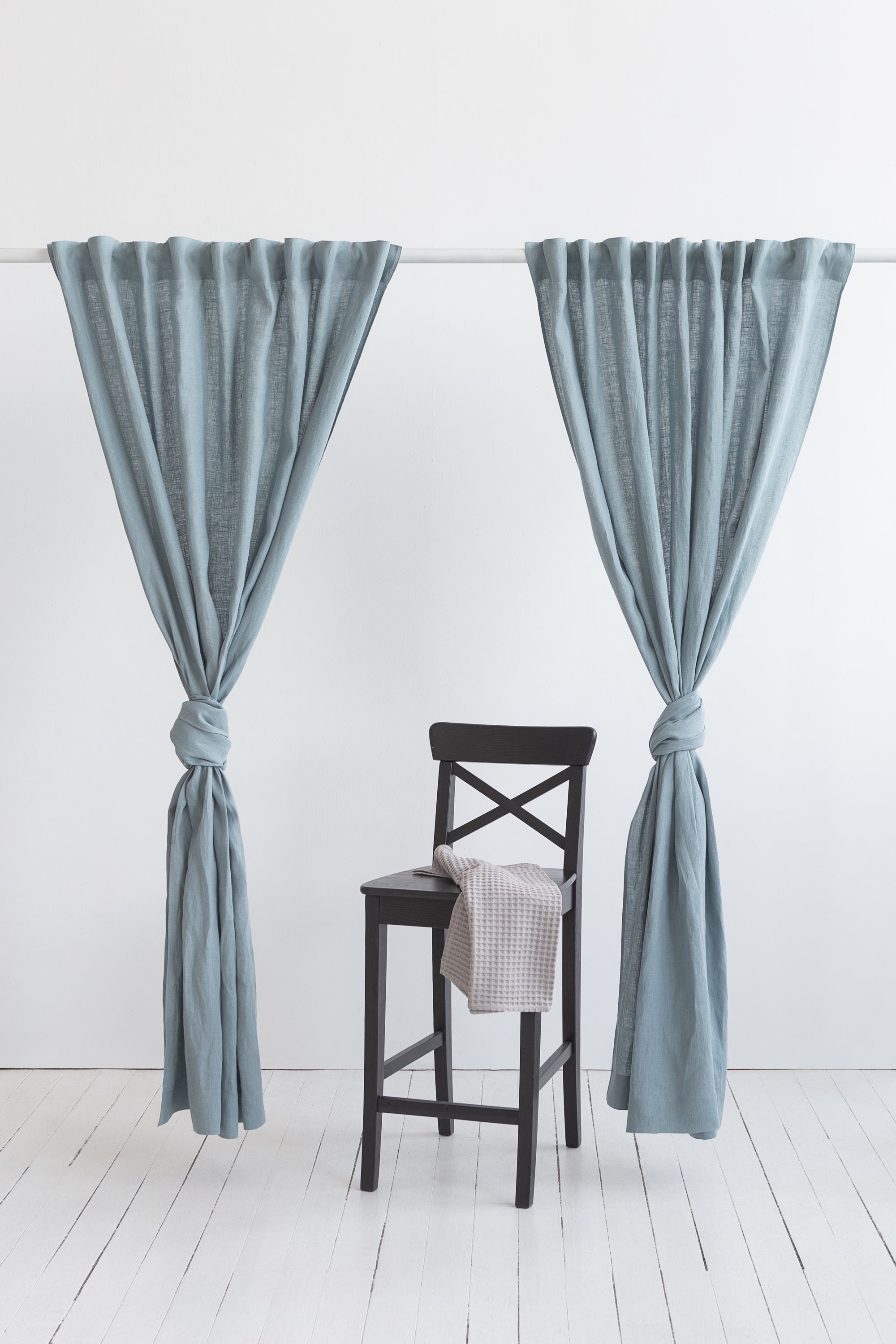 Soft greyish mint linen curtain with multifunctional tape, elegantly draped to showcase its semi-sheer texture and versatile hanging options.