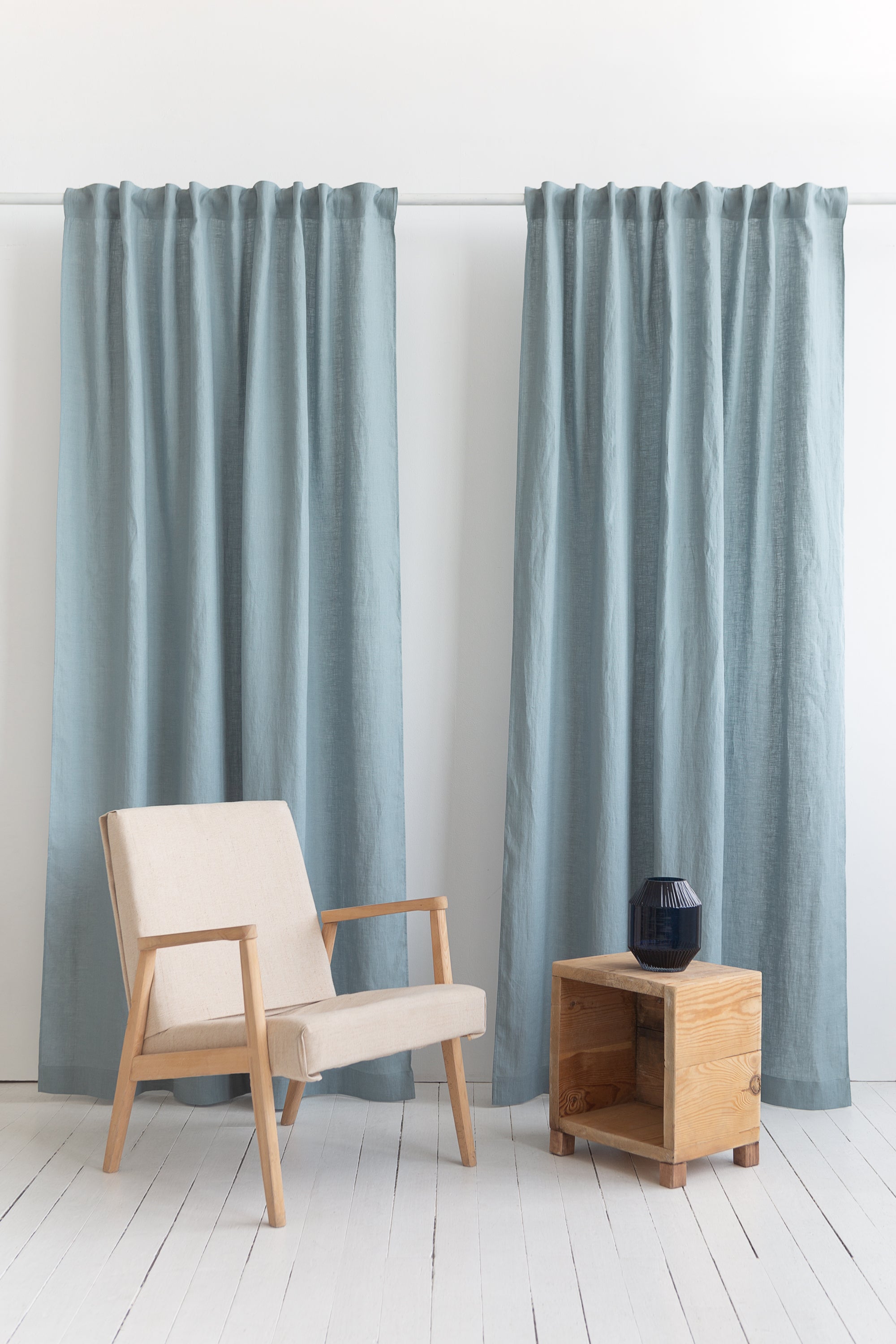 Soft greyish mint linen curtain with multifunctional tape, elegantly draped to showcase its semi-sheer texture and versatile hanging options.