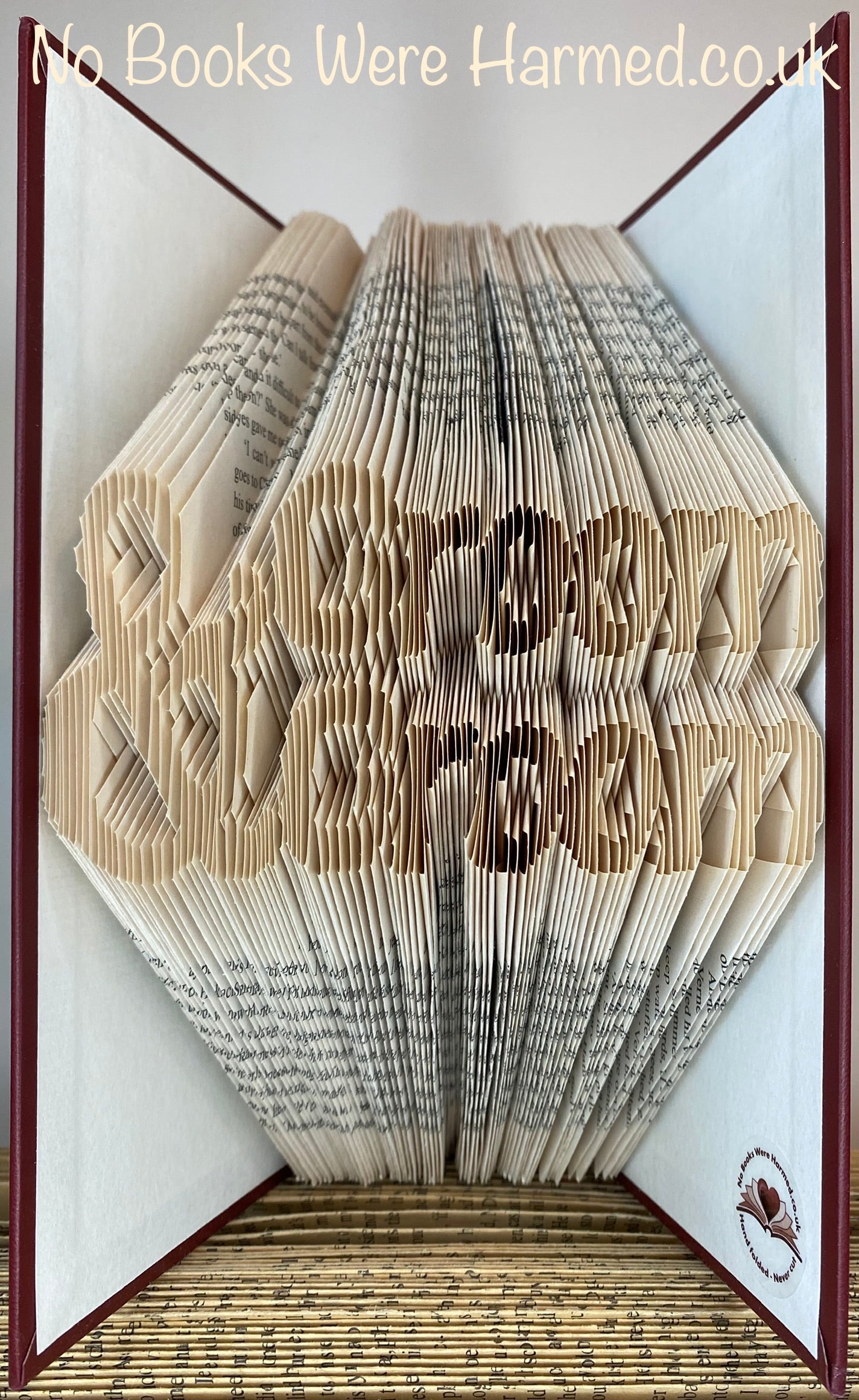 Handcrafted Groom & Groom book art made from vintage books, showcasing intricate page folds and unique designs.