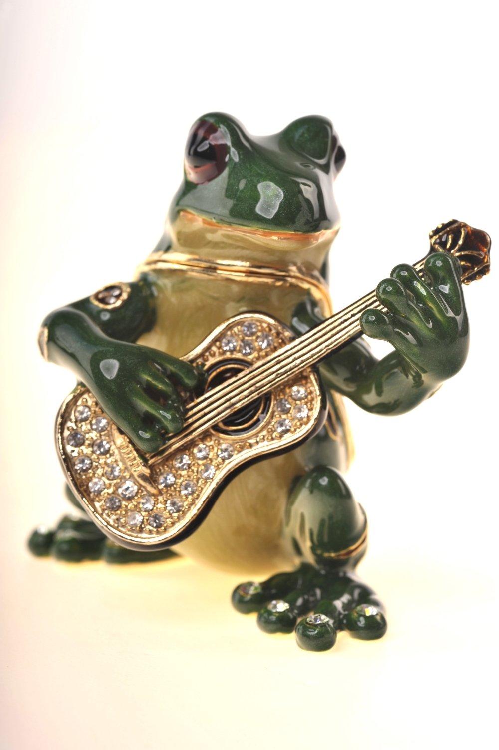 A beautifully crafted enamel painted trinket box shaped like a frog playing a guitar, adorned with Austrian crystals and 925 silver plating.