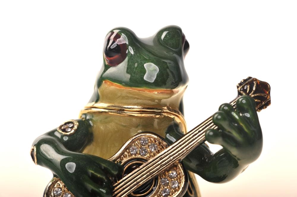 A beautifully crafted enamel painted trinket box shaped like a frog playing a guitar, adorned with Austrian crystals and 925 silver plating.