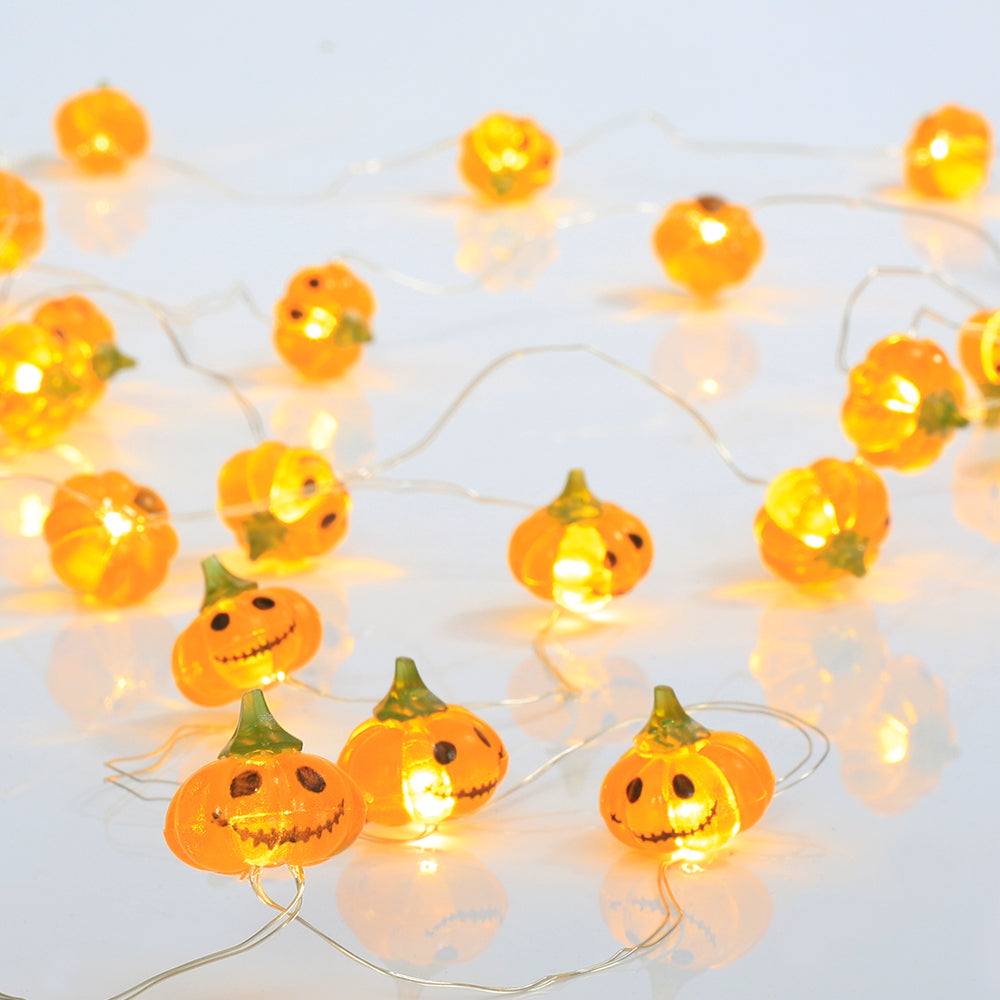 A string of Halloween Smiley Pumpkin lights glowing brightly, showcasing 30 LED pumpkins on a 9.8ft long cable, perfect for festive decorations.