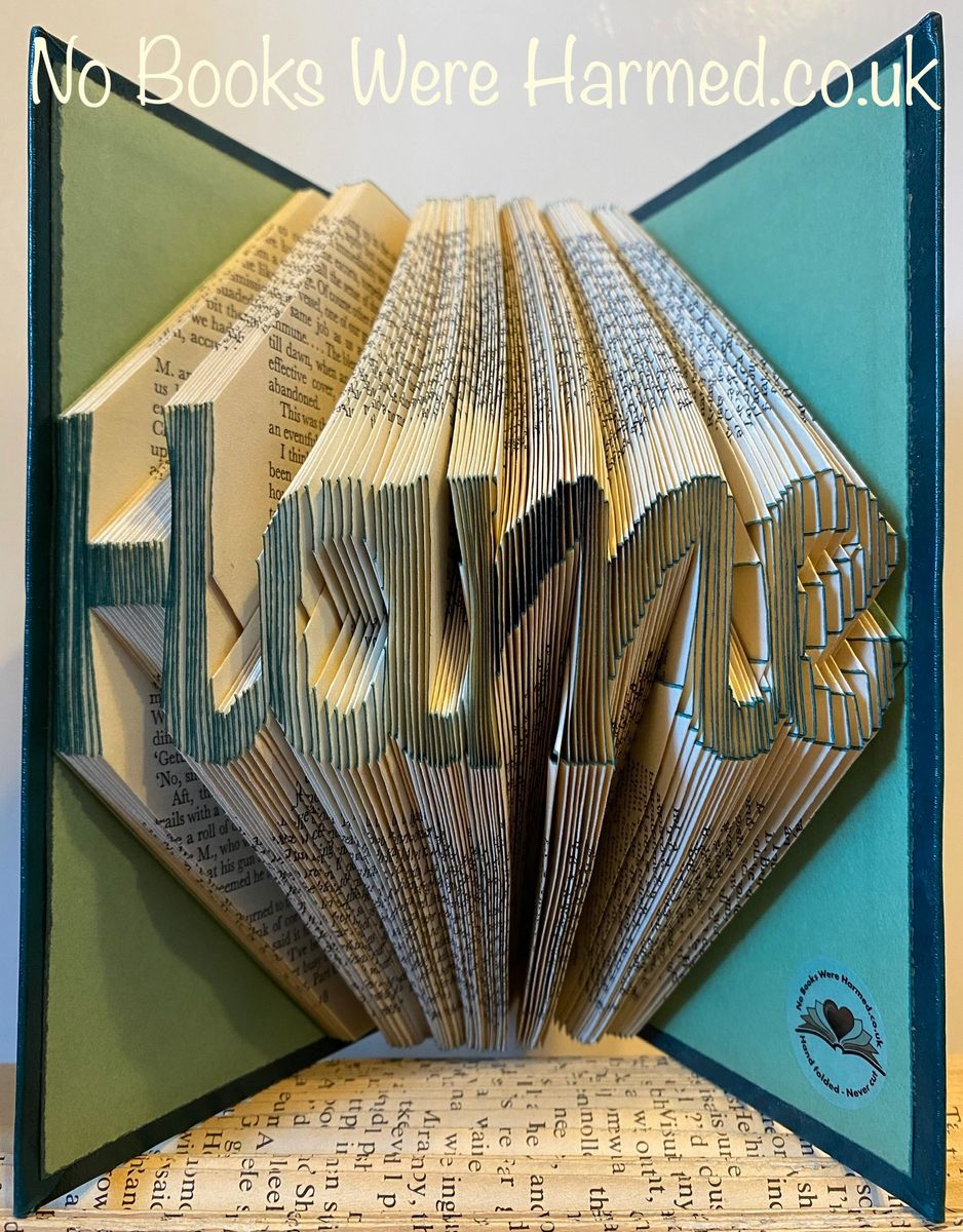 Handcrafted 'Hame' cursive style art made from vintage book pages, showcasing unique folds and colors.