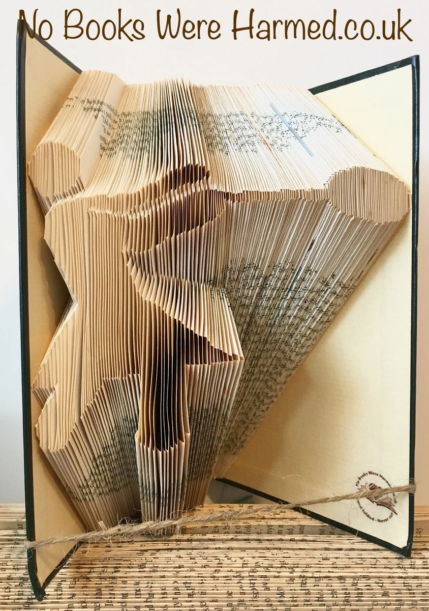 Handcrafted Hammer Thrower art made from vintage book pages, showcasing intricate folds and unique design.