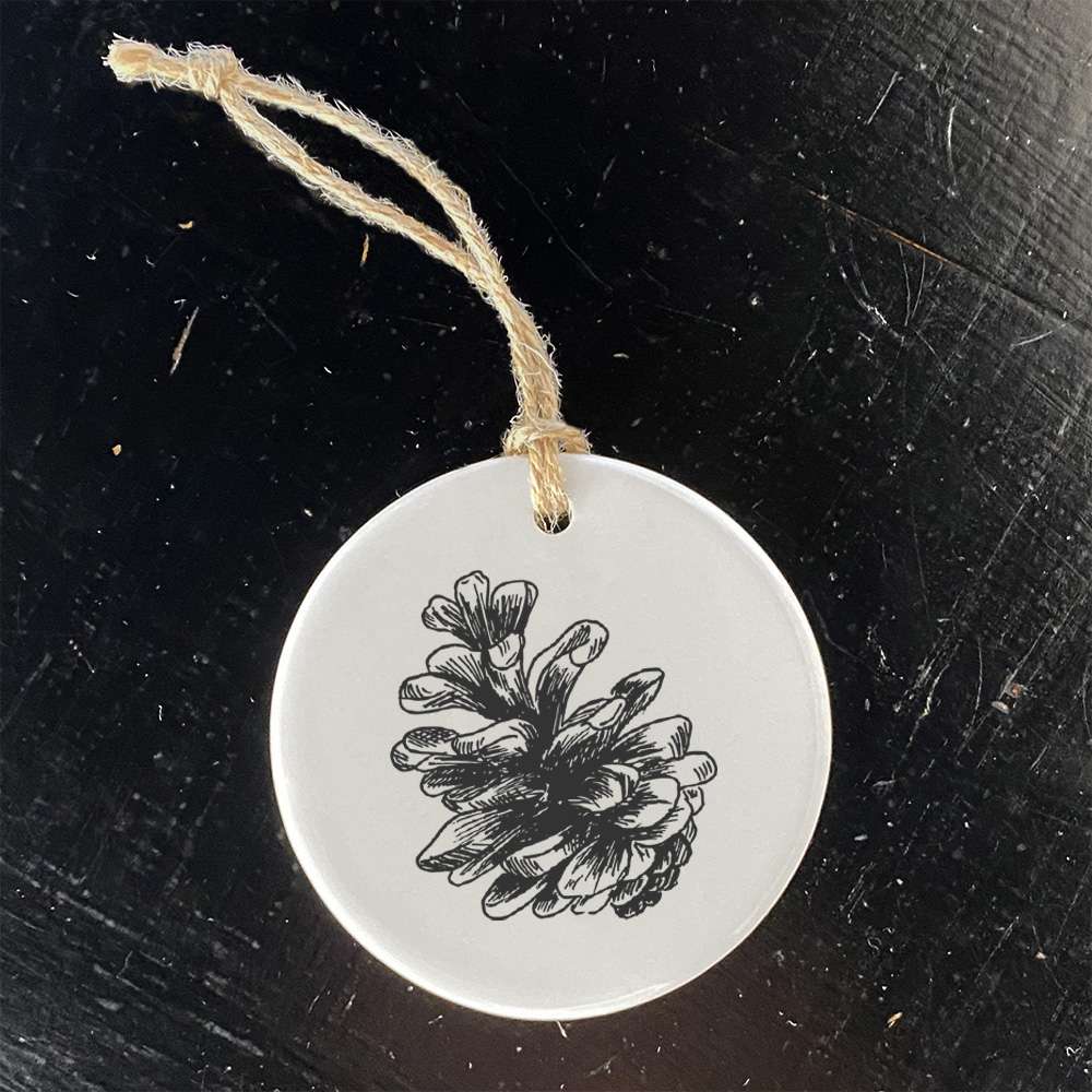 Hand Drawn Pinecone Ornament made of high-quality porcelain with a smooth gloss finish, featuring a unique pinecone design.