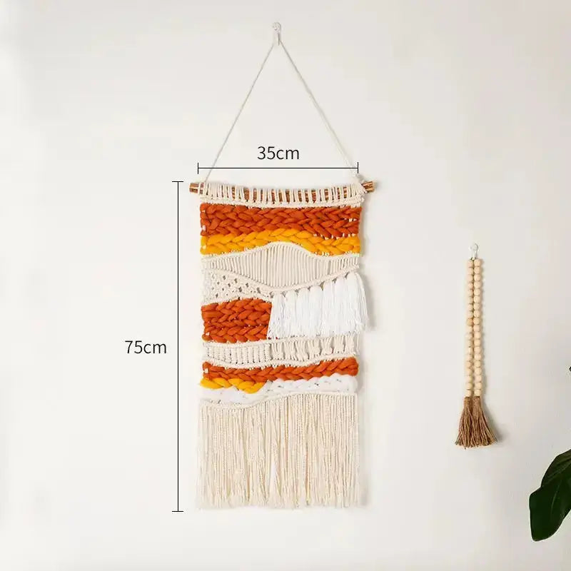 Hand Woven Cotton Wall Art in vibrant orange and white, featuring chunky elements on a wooden stick, showcasing intricate craftsmanship.