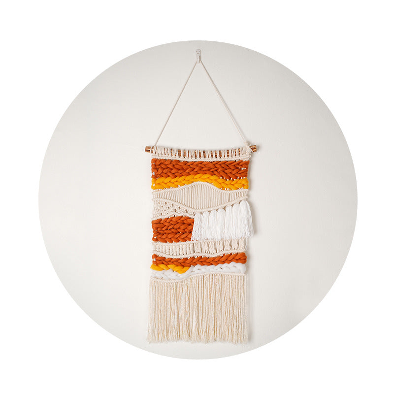 Hand Woven Cotton Wall Art in vibrant orange and white, featuring chunky elements on a wooden stick, showcasing intricate craftsmanship.